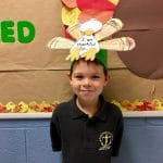 BVP scholar posing with Thanksgiving-themed art project