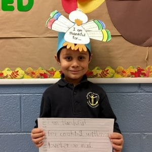 BVP scholar holding a sign about what he's thankful for