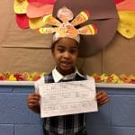 BVP Scholar holding a sign about what she's thankful for