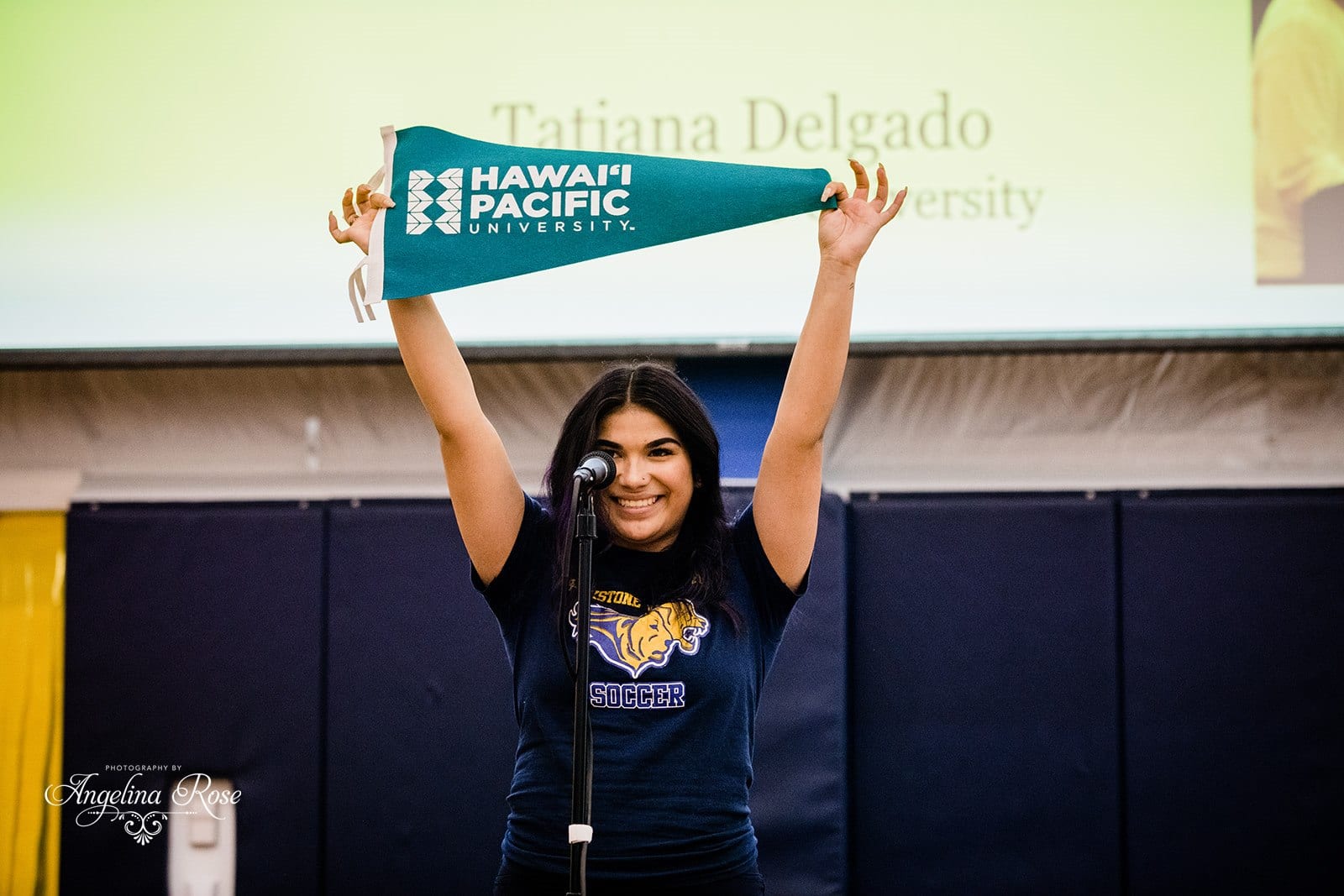 Scholar holding up Hawaii pennant
