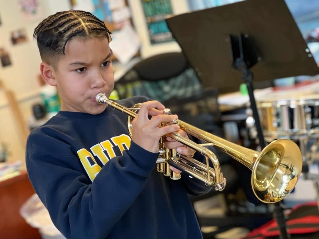 Scholar practicing his trumpet