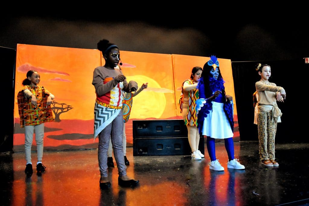 Scholars performing on stage